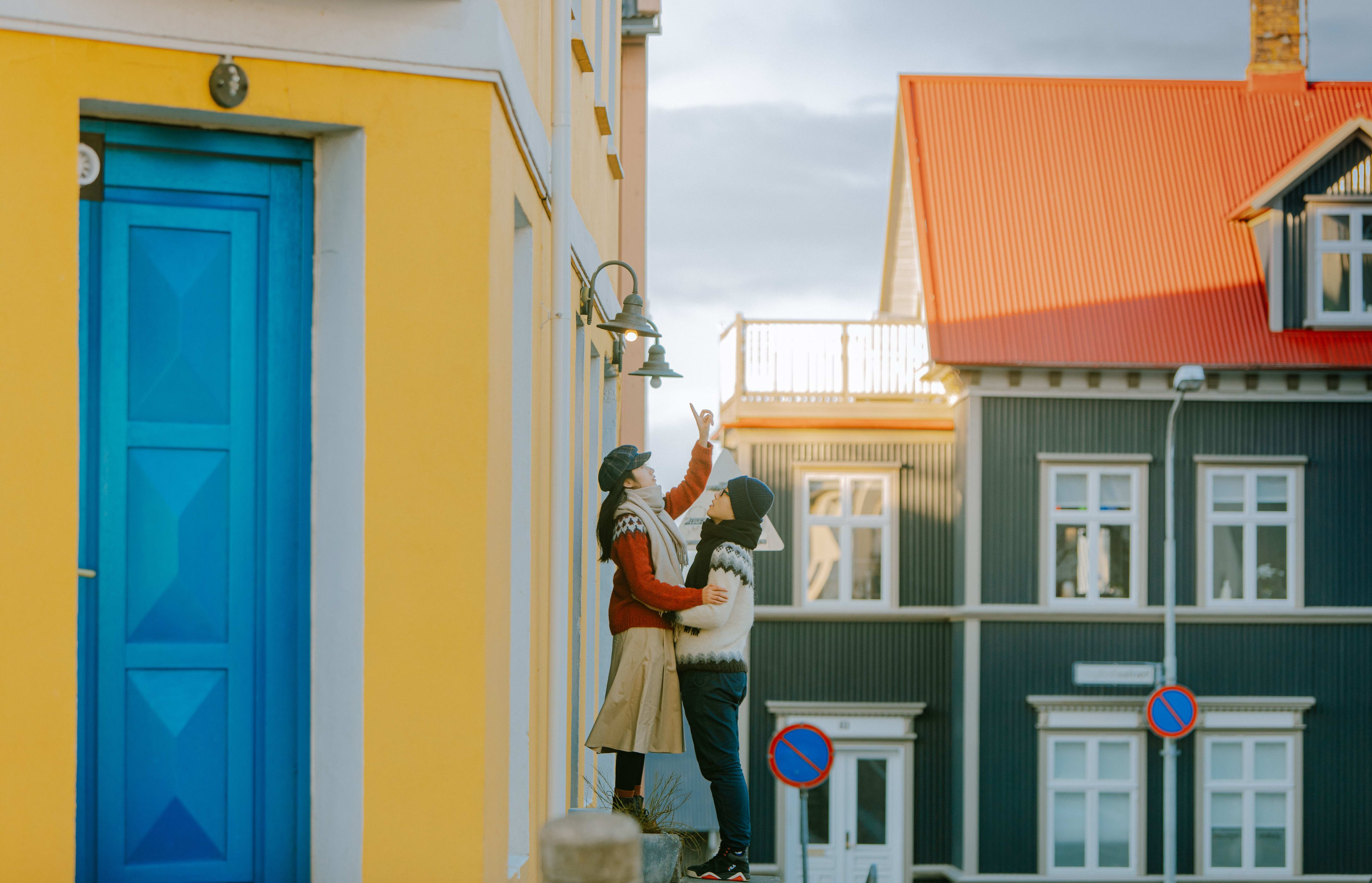 couple between colorful houses of reykjavik