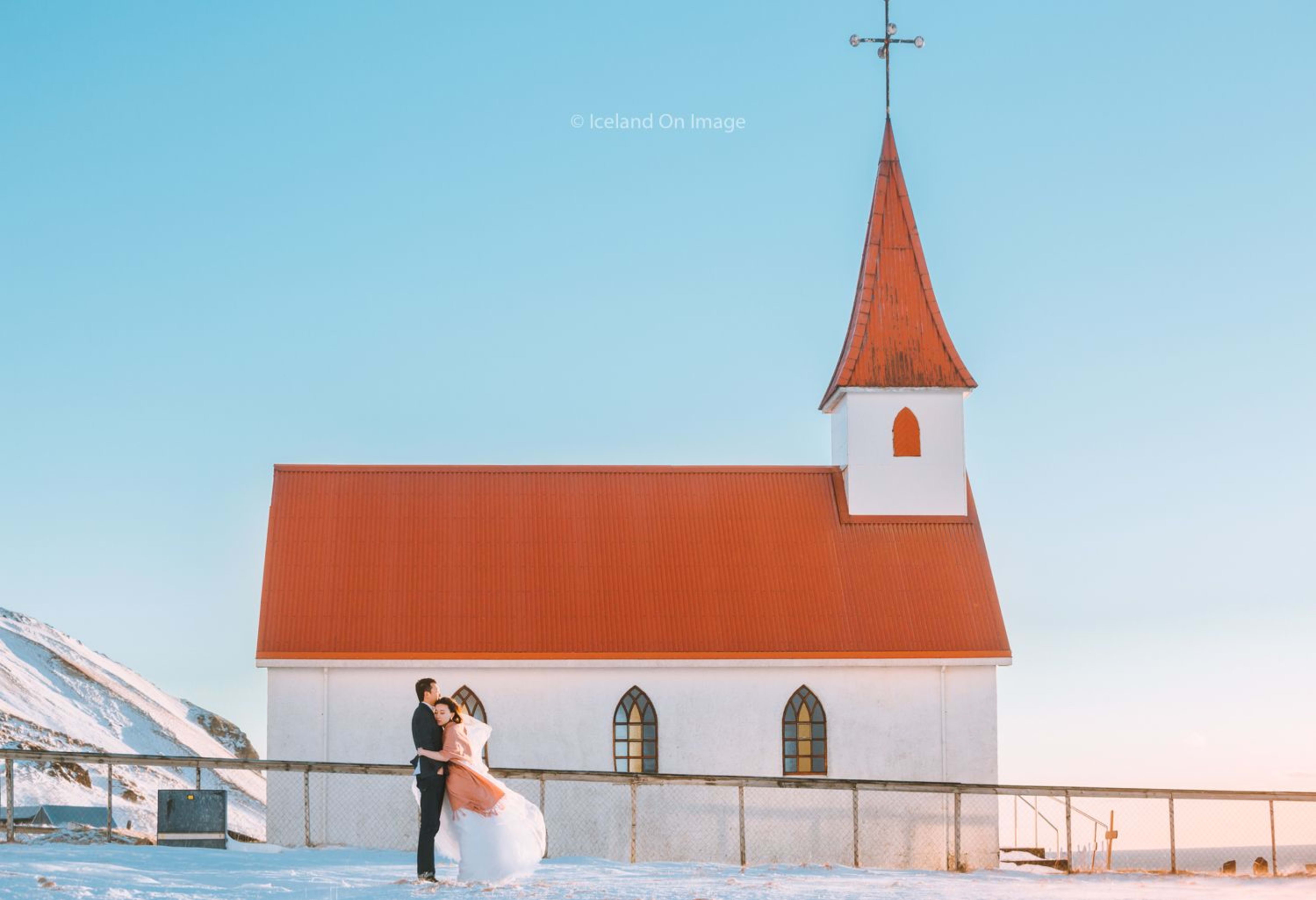 wedding couple at red church of vik