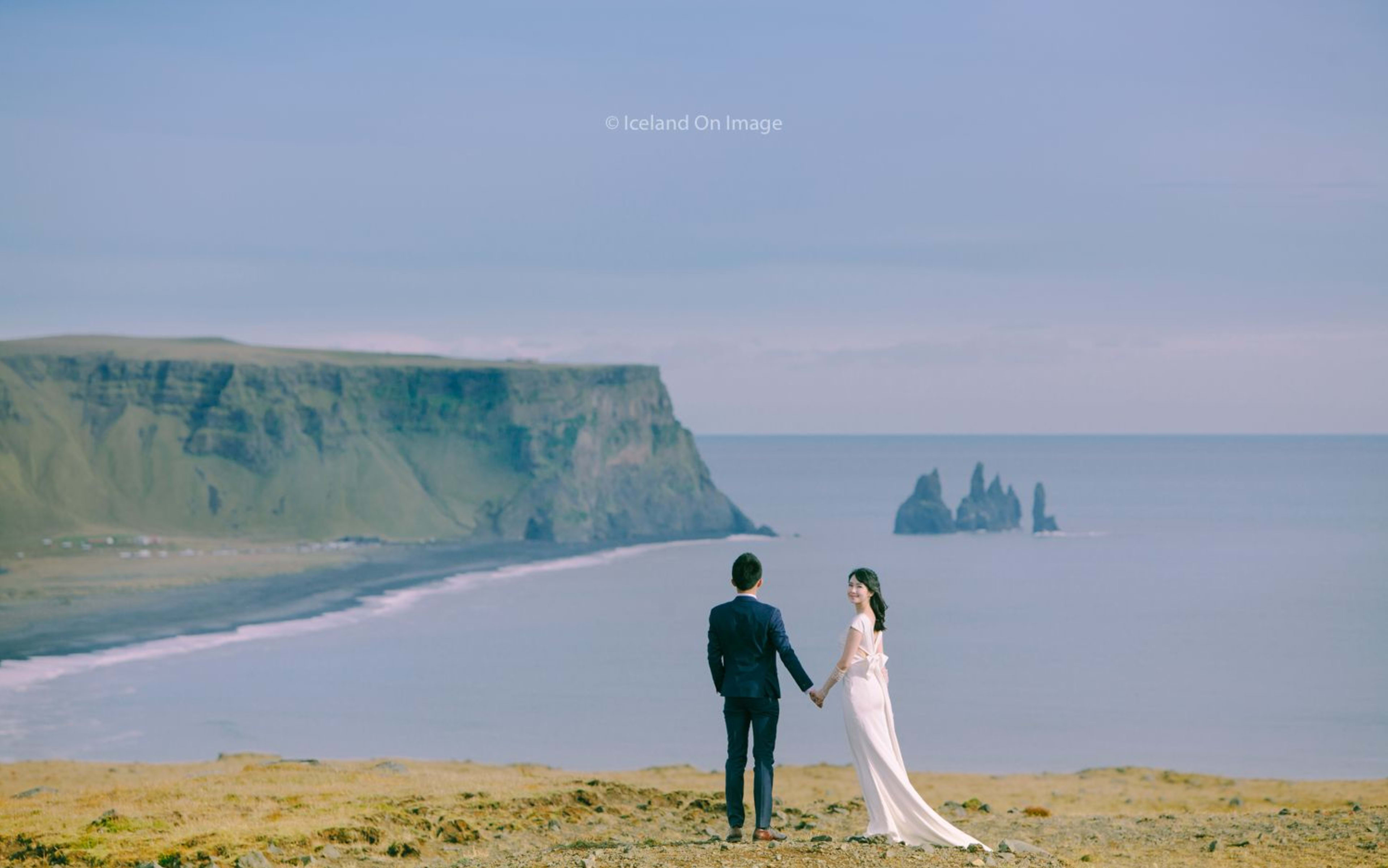 iceland southcoast with couple standing in front of the sea